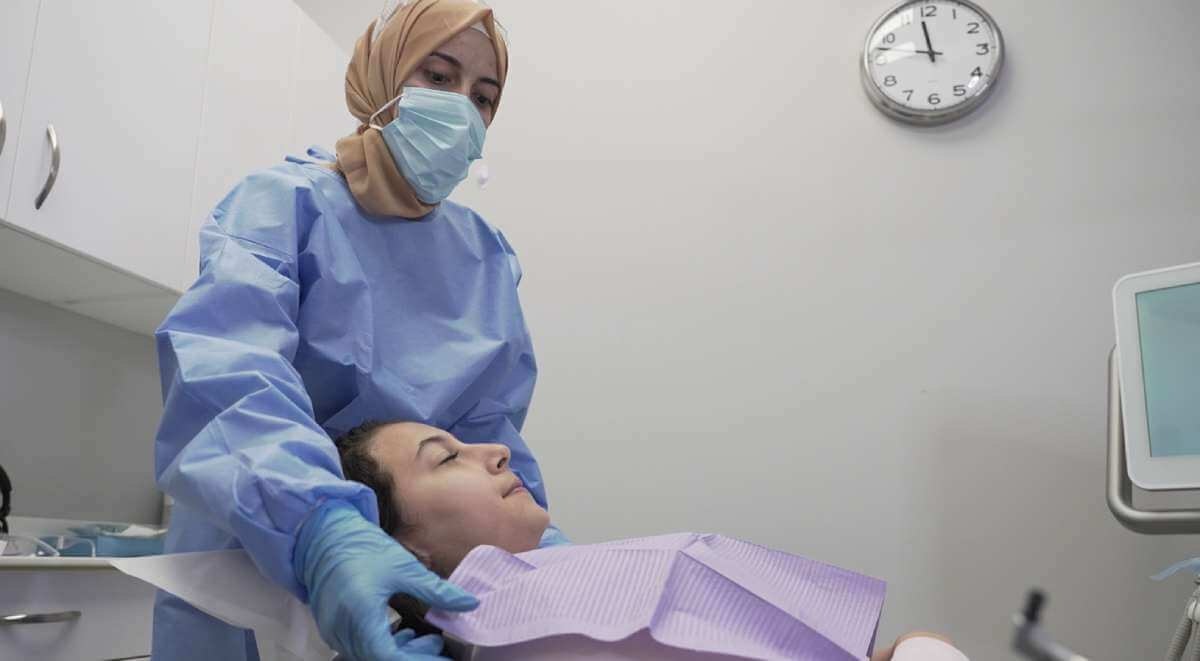 A Dental Hygenist cleaning a patients teeth at Apple Dental Centre